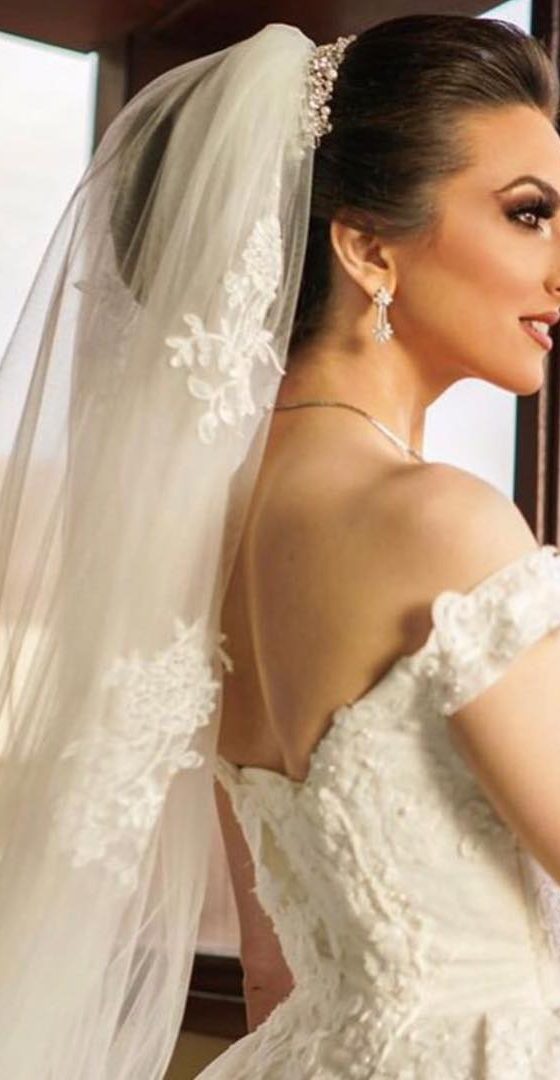 Bride in profile with sculpted glam and cathedral veil
