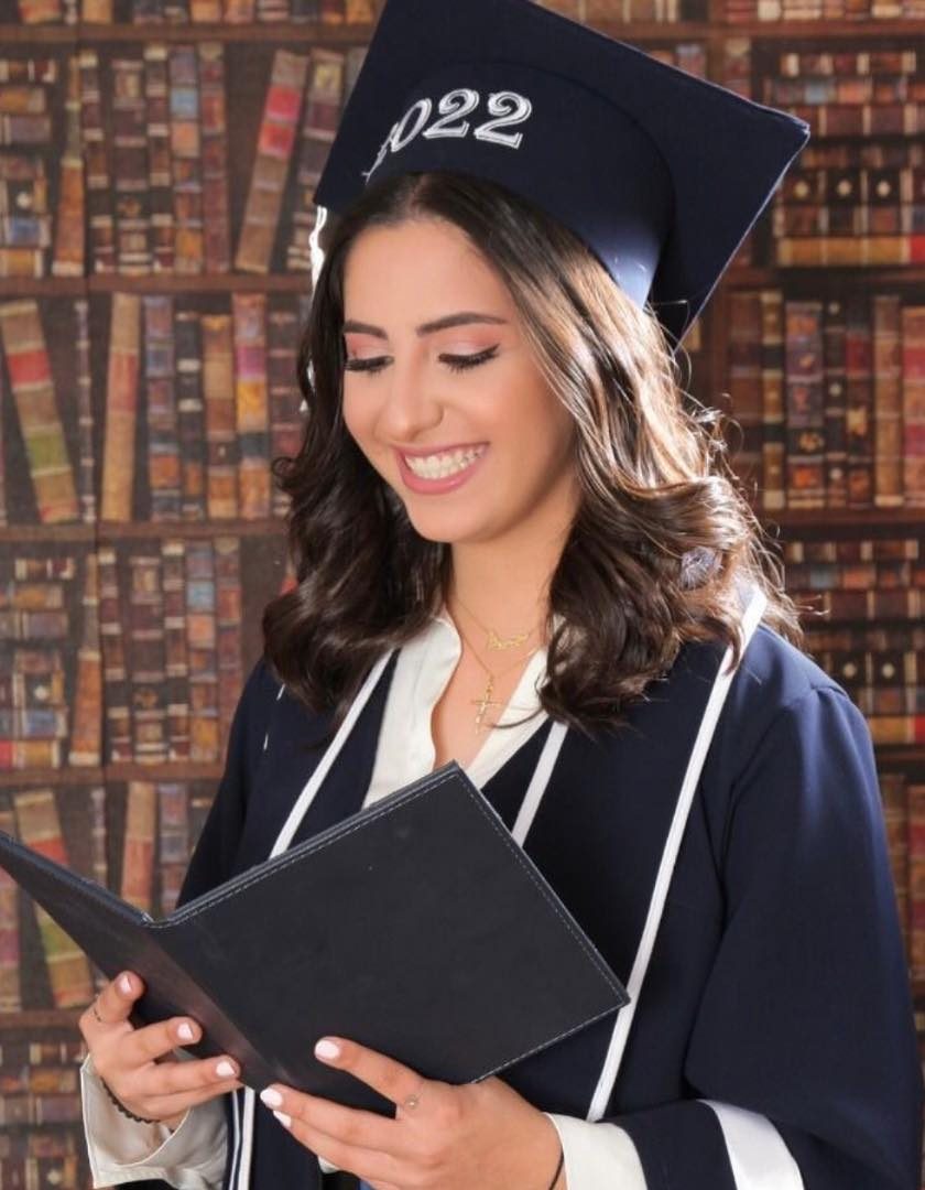 Graduate in cap and gown with fresh glam